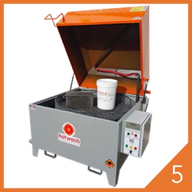 Orange manual parts washer with open lid and grey cabinet base