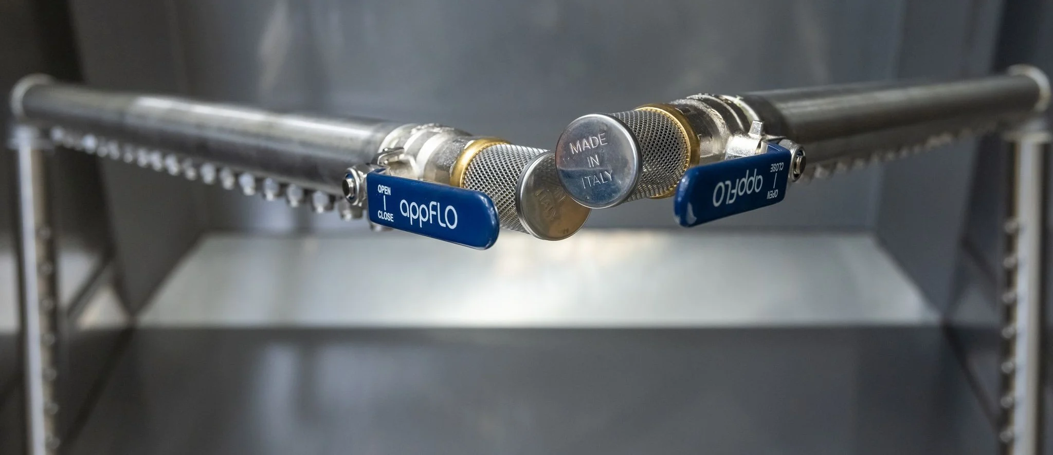 High-pressure spray nozzles inside parts washer chamber